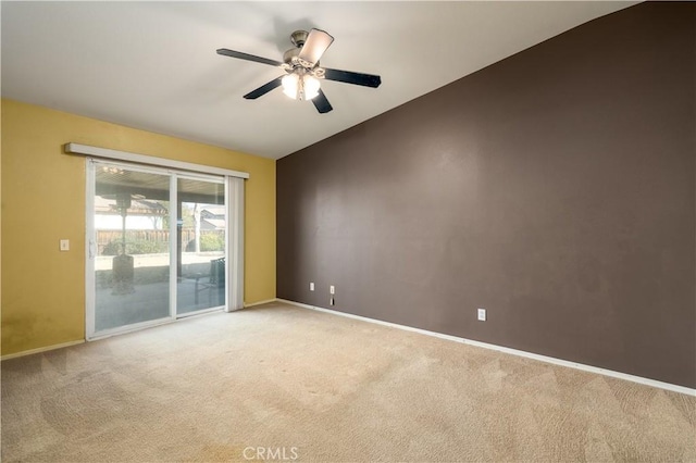 carpeted spare room featuring ceiling fan