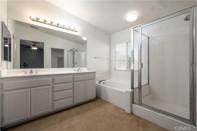 bathroom with ceiling fan, shower with separate bathtub, vanity, and vaulted ceiling