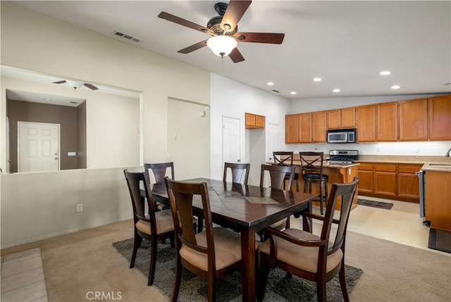 dining area featuring ceiling fan, lofted ceiling, and sink