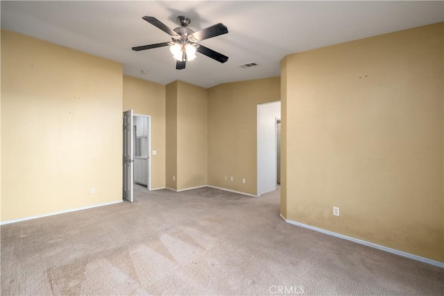 carpeted spare room with ceiling fan