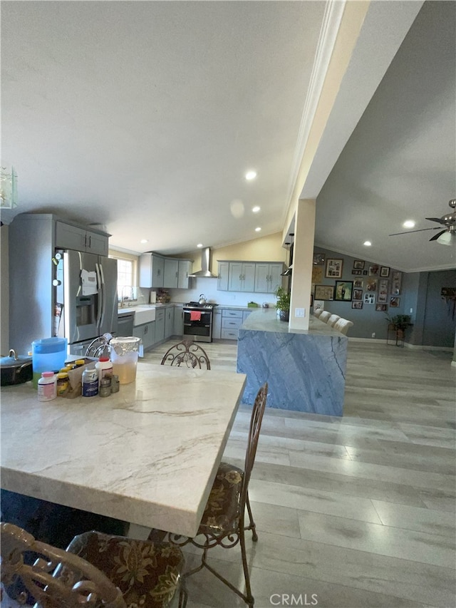 unfurnished dining area featuring ceiling fan, ornamental molding, and lofted ceiling