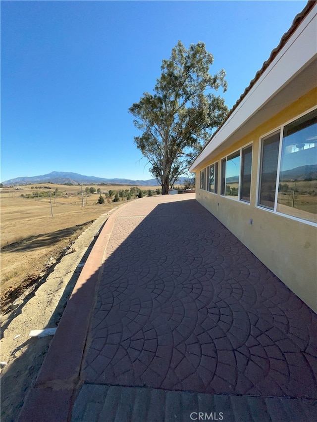 exterior space with a rural view and a mountain view