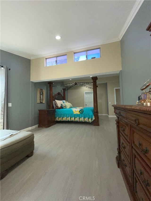 bedroom featuring ornamental molding and light wood-type flooring