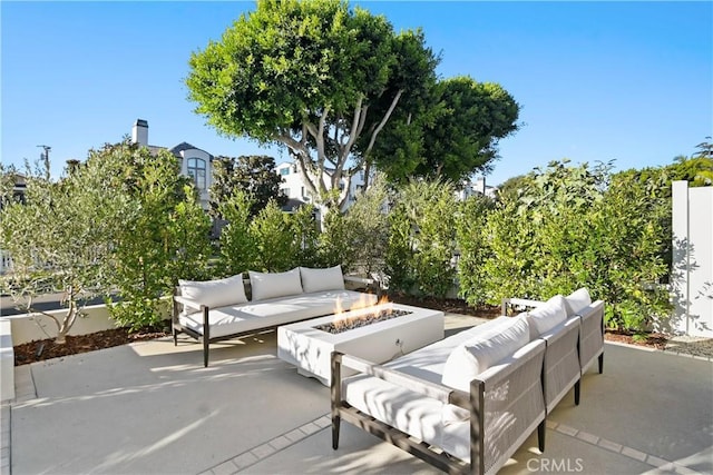 view of patio / terrace featuring an outdoor living space with a fire pit