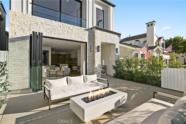 view of patio / terrace featuring an outdoor living space with a fire pit