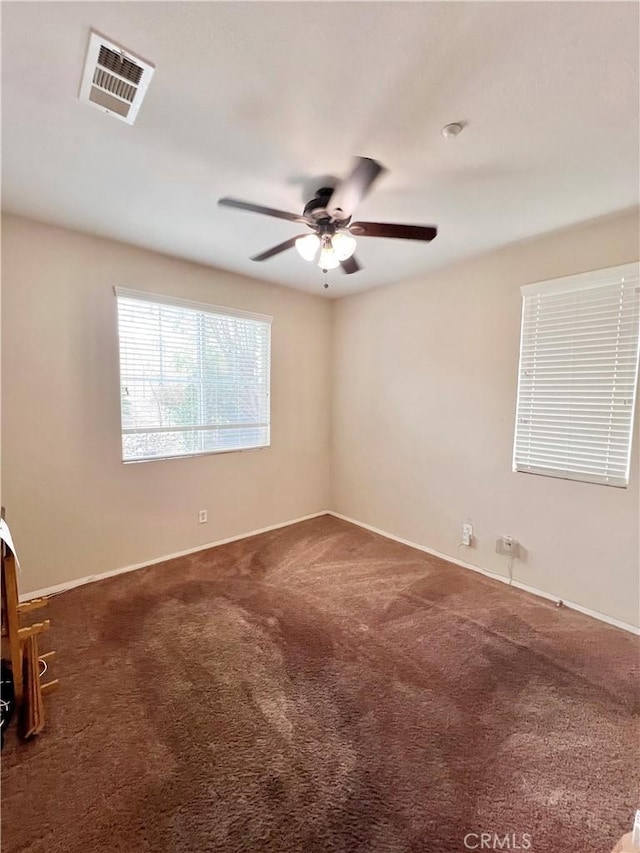 carpeted empty room featuring ceiling fan