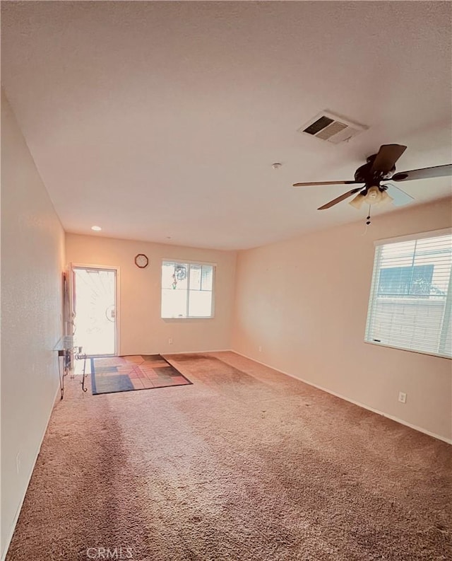 unfurnished room featuring ceiling fan and carpet floors