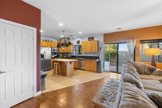 living room featuring light tile patterned floors and sink