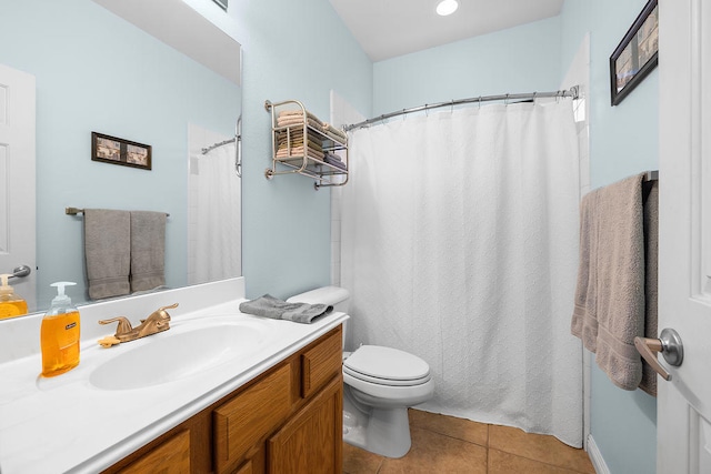 bathroom featuring toilet, vanity, and tile patterned flooring