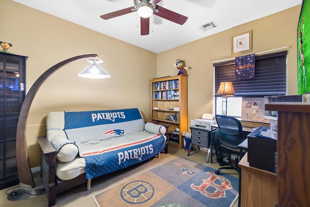 bedroom featuring ceiling fan and carpet