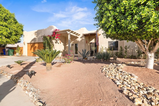 pueblo-style house with a garage