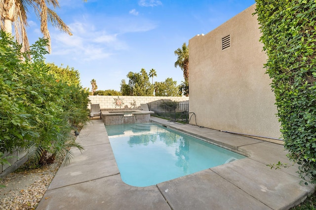 view of pool with an in ground hot tub