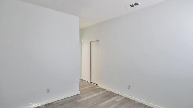 spare room featuring light hardwood / wood-style floors