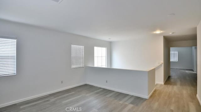 unfurnished room with light wood-type flooring