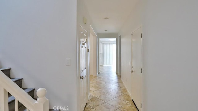 corridor featuring light tile patterned floors