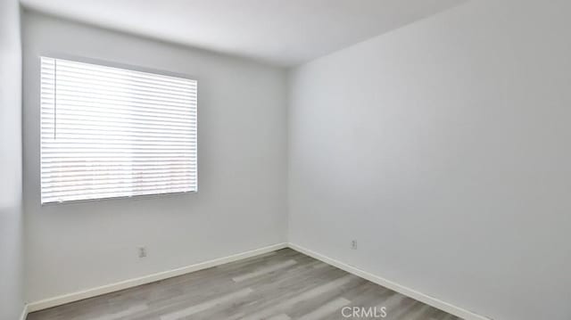 spare room with light hardwood / wood-style flooring