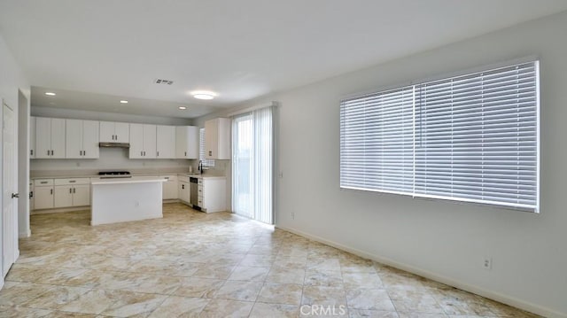 kitchen featuring range, white cabinetry, and a kitchen island