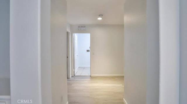 corridor with light wood-type flooring