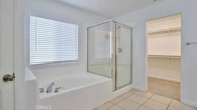 bathroom with independent shower and bath, tile patterned flooring, and plenty of natural light