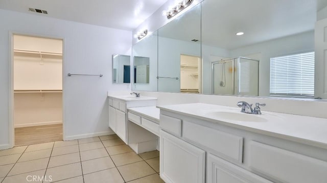 bathroom featuring vanity, tile patterned floors, and a shower with door