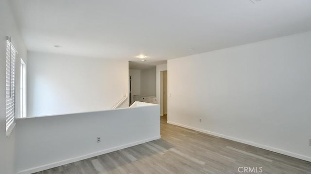 unfurnished room with plenty of natural light and light wood-type flooring