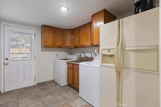 clothes washing area with sink and cabinets