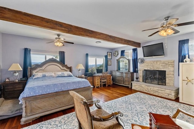 bedroom with ceiling fan, hardwood / wood-style floors, and beamed ceiling