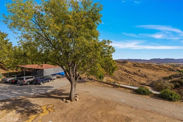 view of front of house with a carport and a mountain view