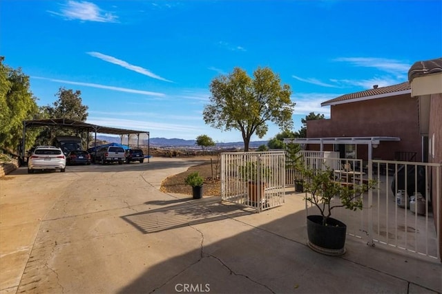 view of patio with a mountain view and a carport