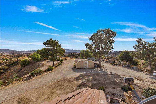 exterior space featuring a storage shed and a mountain view