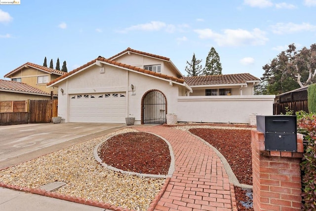 mediterranean / spanish-style house with a garage