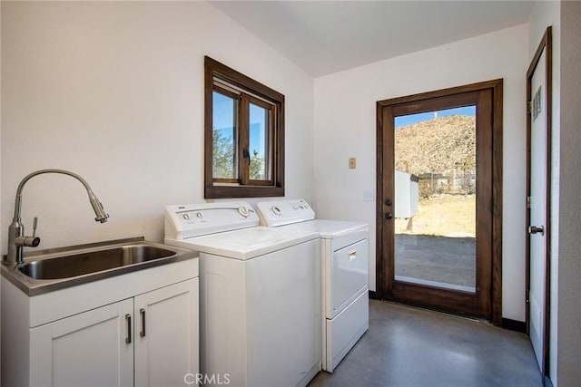 washroom with sink, a mountain view, washing machine and clothes dryer, and cabinets