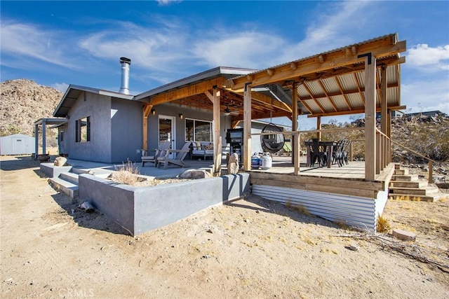 exterior space with an outdoor fire pit and a patio