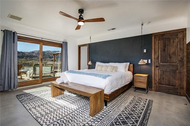 bedroom featuring ceiling fan, a mountain view, and access to outside