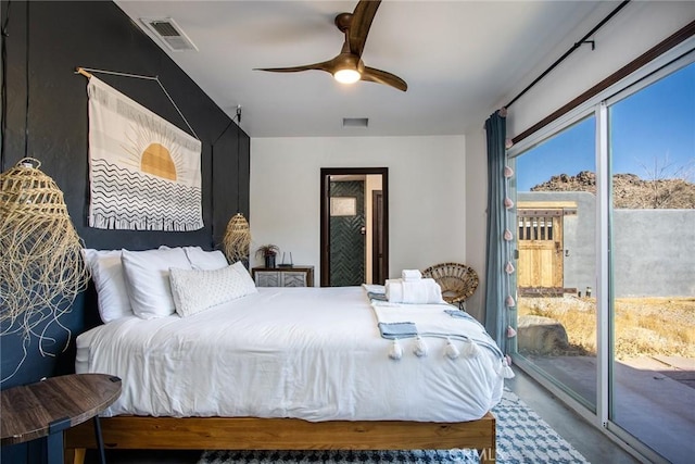 bedroom featuring ceiling fan, access to exterior, and concrete floors