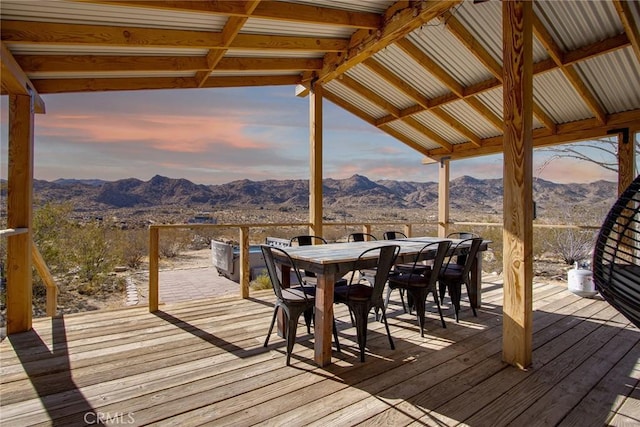 deck at dusk featuring a mountain view