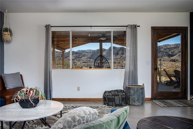 living room with a mountain view and concrete floors