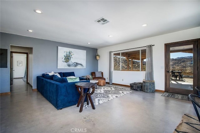 living room with plenty of natural light and concrete flooring