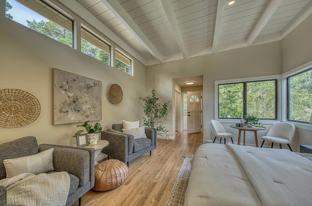 bedroom featuring light hardwood / wood-style floors and beam ceiling