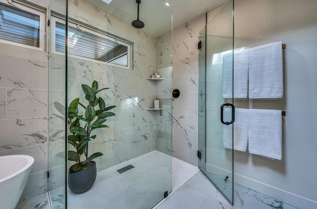 bathroom featuring tile walls and separate shower and tub