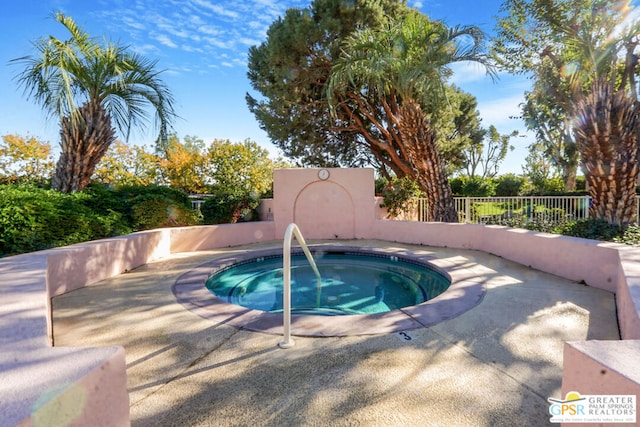 view of pool with an in ground hot tub