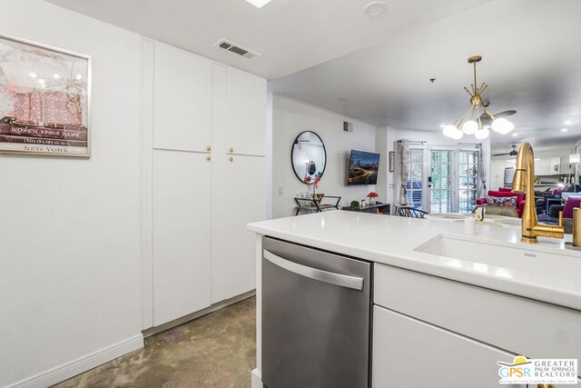 kitchen with hanging light fixtures, dishwasher, sink, and white cabinets