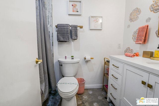 bathroom featuring toilet, vanity, and concrete flooring