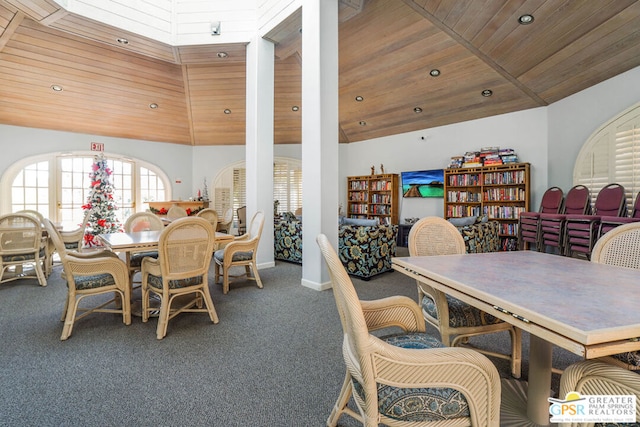 carpeted dining area featuring wooden ceiling and high vaulted ceiling