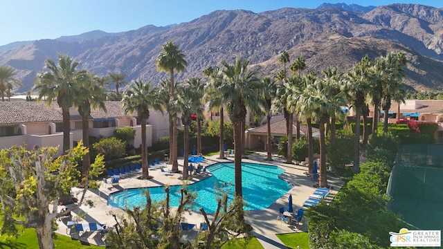 view of swimming pool featuring a mountain view and a patio area