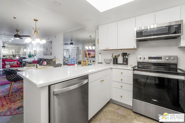 kitchen with white cabinetry, appliances with stainless steel finishes, sink, and kitchen peninsula