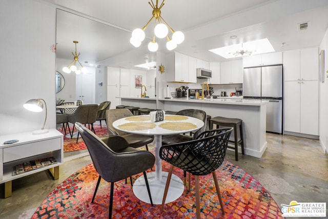 dining room featuring sink and ceiling fan