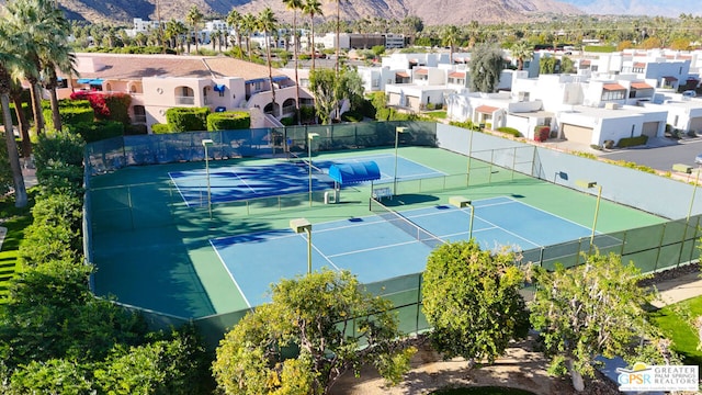 view of tennis court featuring a mountain view