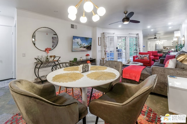 dining room featuring crown molding and ceiling fan with notable chandelier