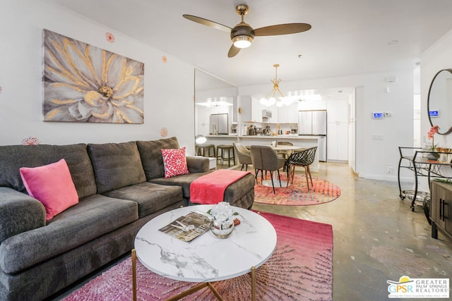 living room with ceiling fan with notable chandelier